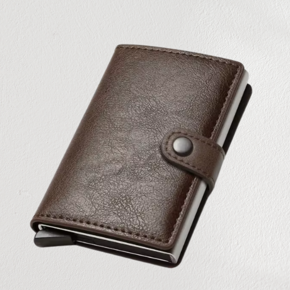 Brown leather wallet with metal clip on a light gray background